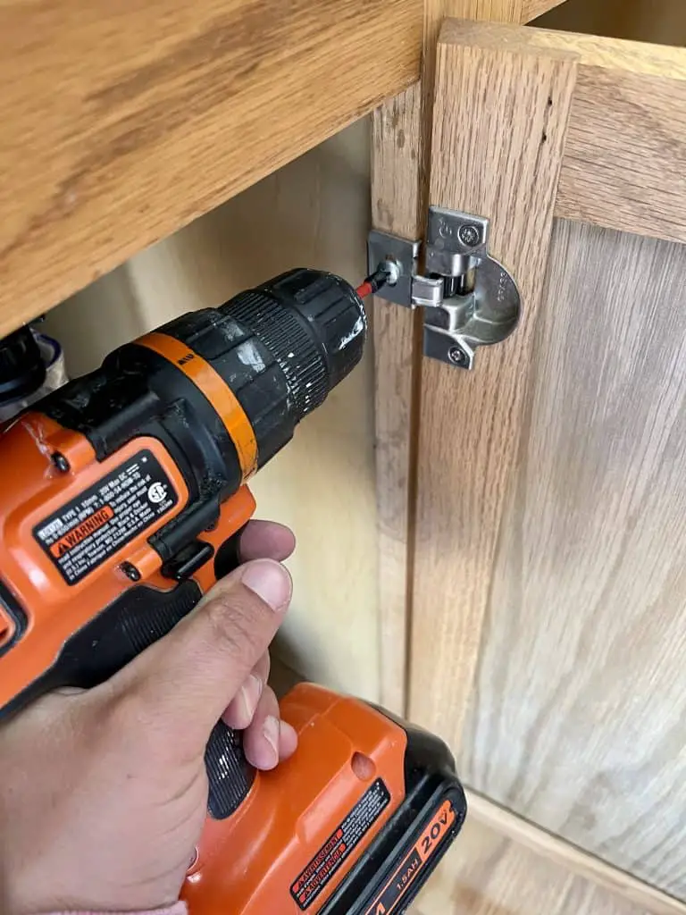 How to Paint Kitchen Cabinets that are Stained 7 drill removing hinge from door